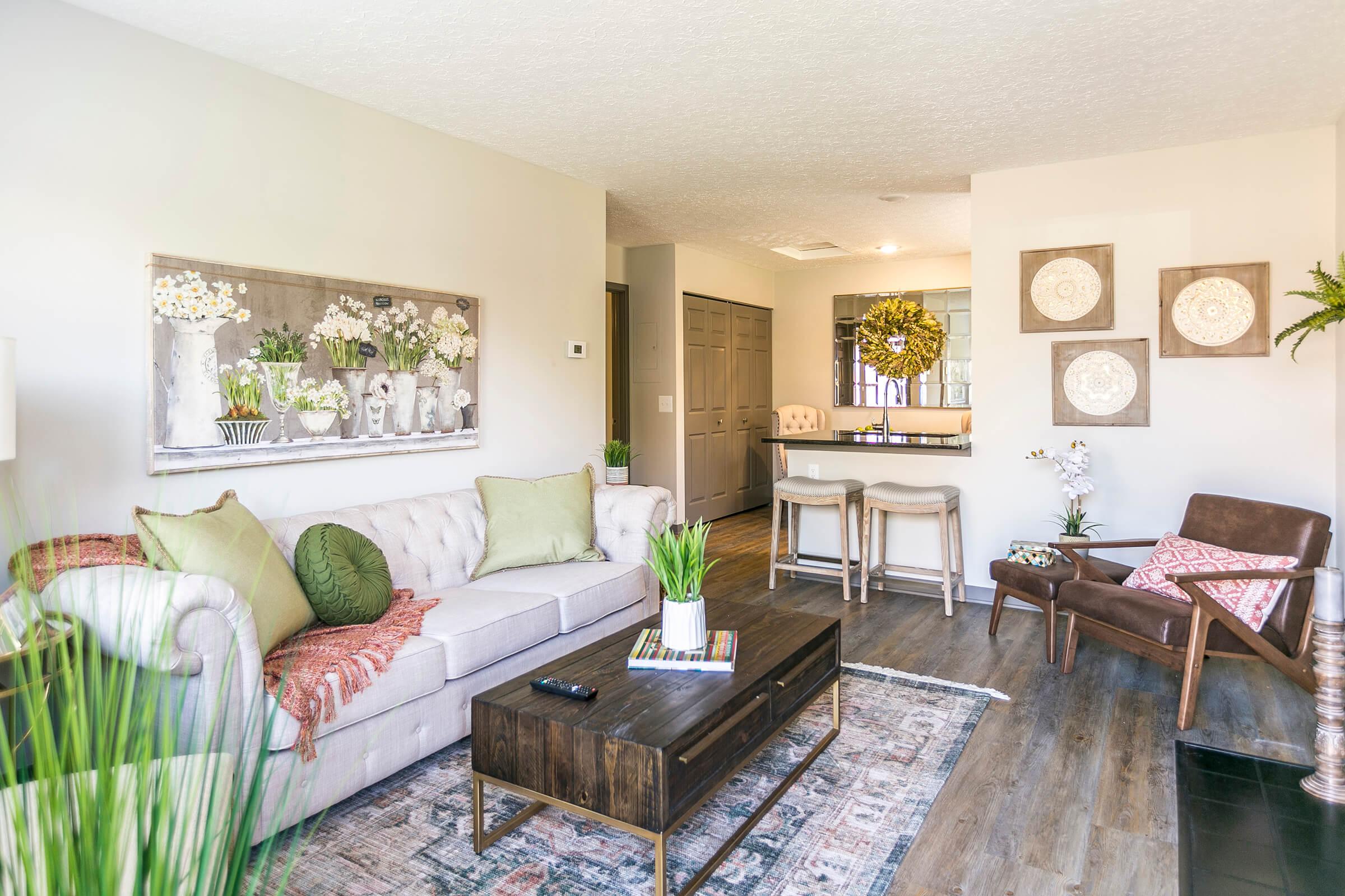 Bright living room with white couch and stylish decor.